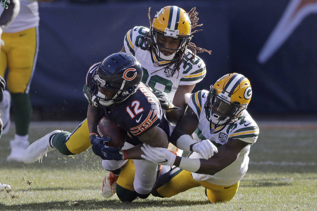 Chicago Bears wide receiver Allen Robinson (12) is tackled by Green Bay Packers cornerbacks Tra ...