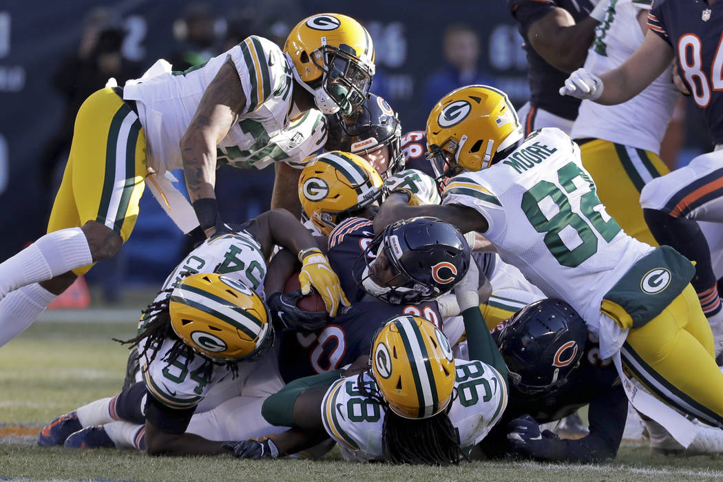 Chicago Bears running back Benny Cunningham (30) is tackled by Green Bay Packers defenders duri ...
