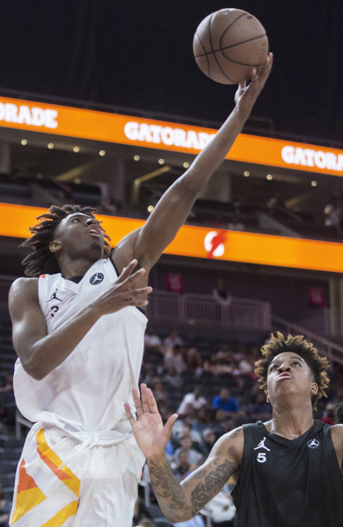 Tyrese Maxey (3) drives baseline past Armando Bacot Jr. (5) in the second half during the Jorda ...