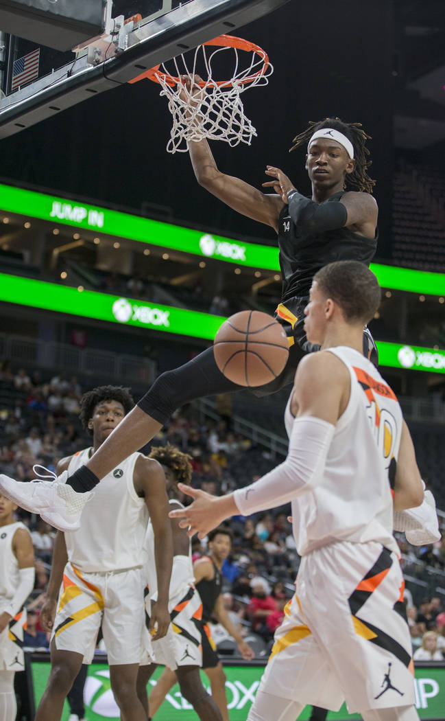 C.J. Walker (14) dunks over Samuell Williamson (10) in the first half during the Jordan Brand C ...