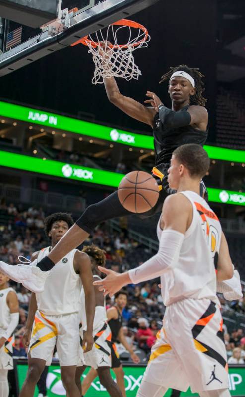 C.J. Walker (14) dunks over Samuell Williamson (10) in the first half during the Jordan Brand C ...