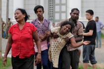 Relatives of a blast victim grieve outside a morgue in Colombo, Sri Lanka, Sunday, April 21, 20 ...