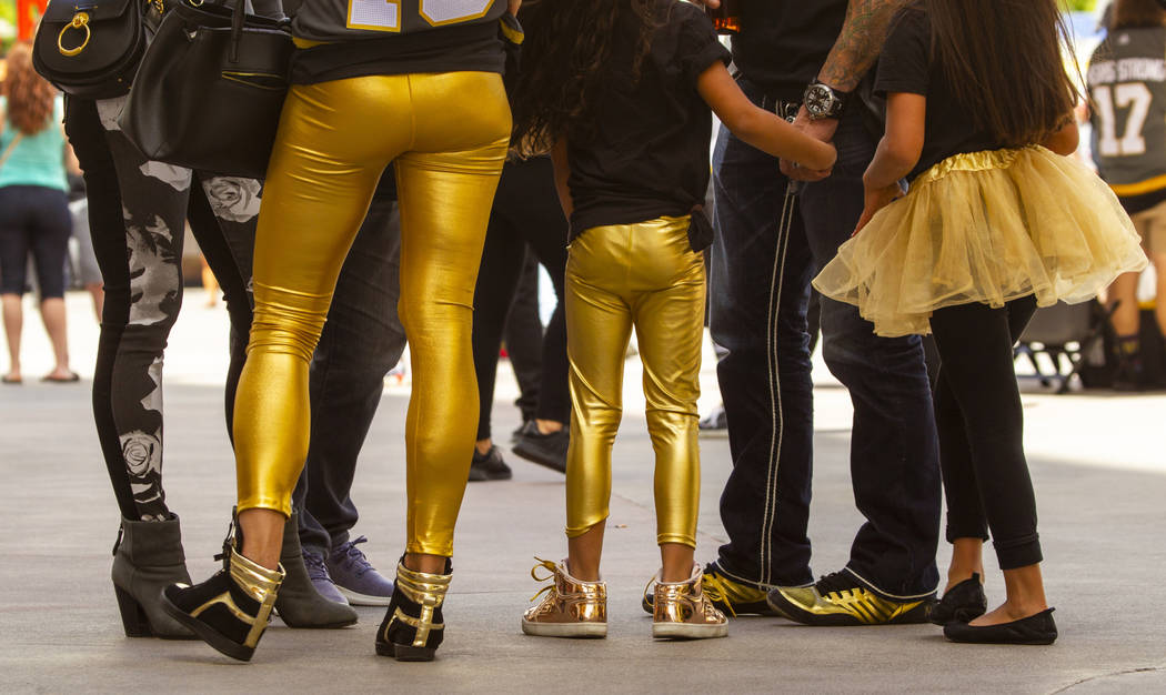 Fans wear all styles of gold clothing before the first period start of Game 6 of an NHL Western ...