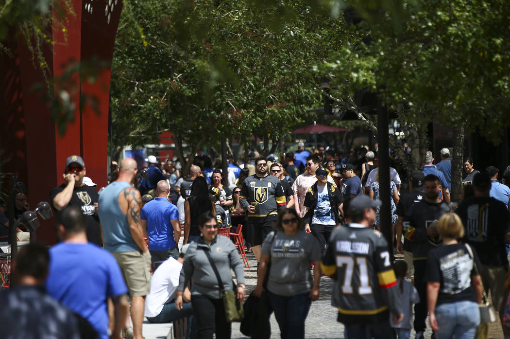 Golden Knights fans walk through the Park before the start of Game 6 of an NHL Western Conferen ...