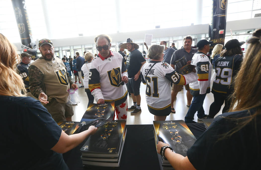 Golden Knights fans pickup gameday posters before the start of Game 6 of an NHL Western Confere ...