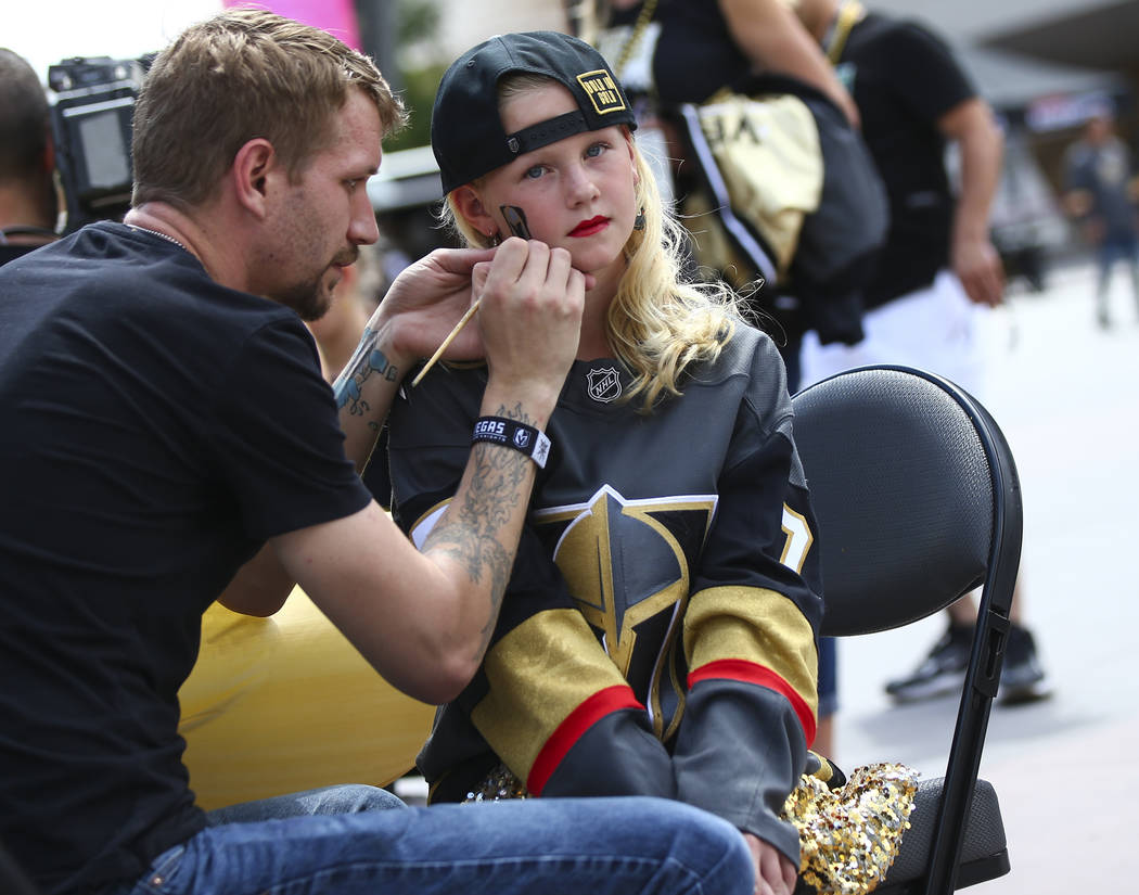 Alexis Lunkwitz, 10, of Las Vegas, gets her face painted before the start of Game 6 of an NHL W ...
