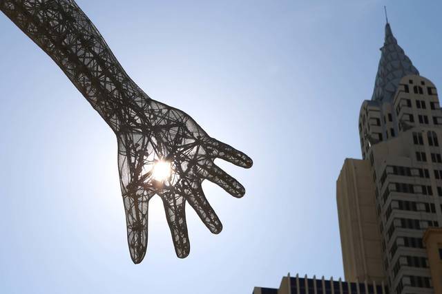 The morning sun light rays pierce through the Bliss Dance sculpture at The Park near T-Mobile A ...