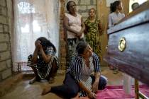 Relatives weep near the coffin with the remains of 12-year Sneha Savindi, who was a victim of E ...