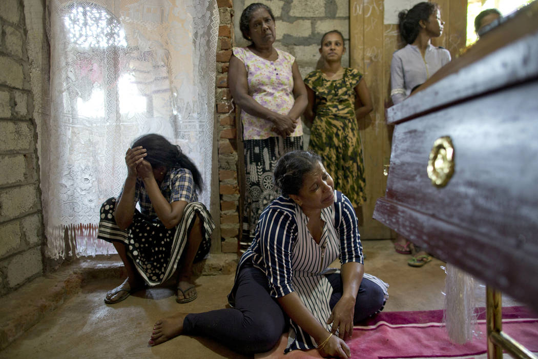 Relatives weep near the coffin with the remains of 12-year Sneha Savindi, who was a victim of E ...