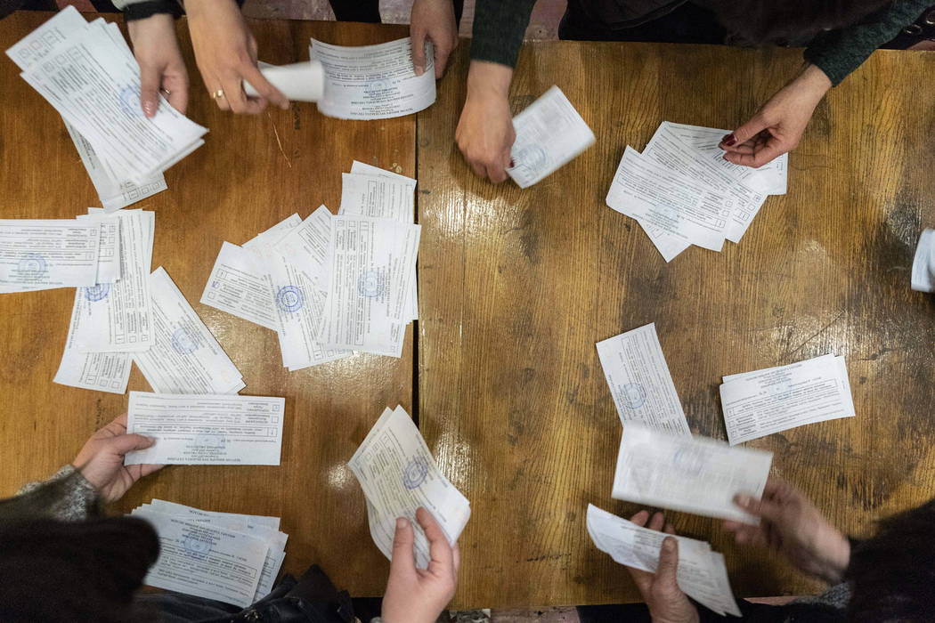 Election officials start counting ballots at the polling station after the second round of pres ...