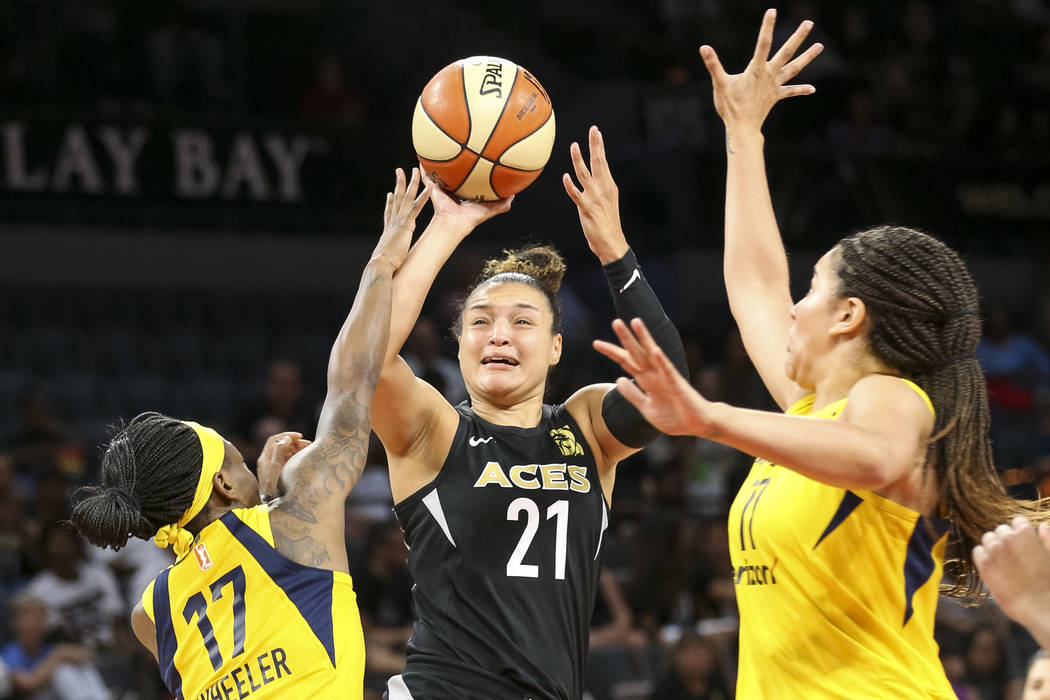 Las Vegas Aces guard Kayla McBride (21) takes a shot through Indiana Fever guard Erica Wheeler ...