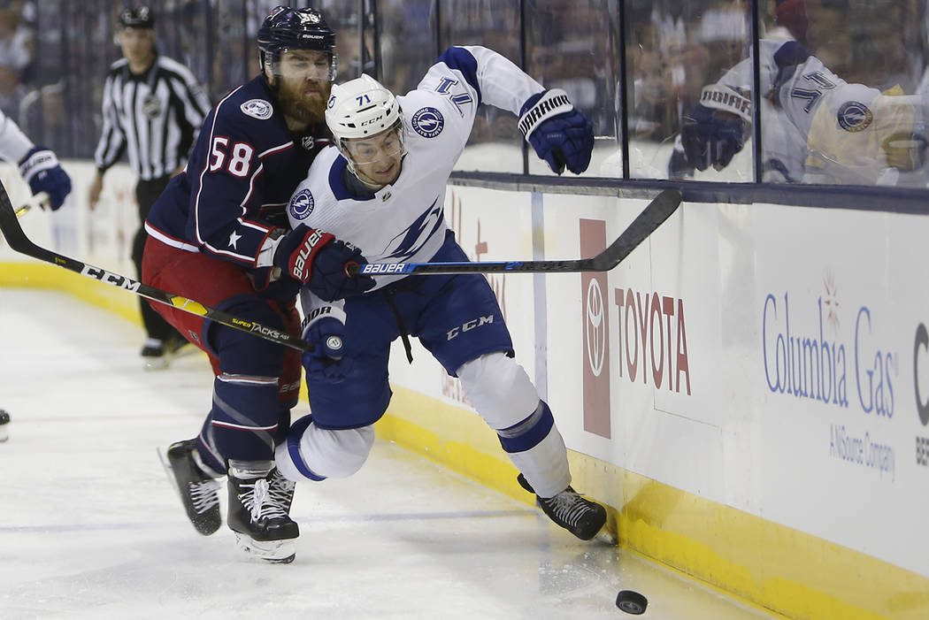 Columbus Blue Jackets' David Savard, left, checks Tampa Bay Lightning's Anthony Cirelli during ...