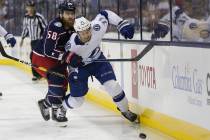 Columbus Blue Jackets' David Savard, left, checks Tampa Bay Lightning's Anthony Cirelli during ...