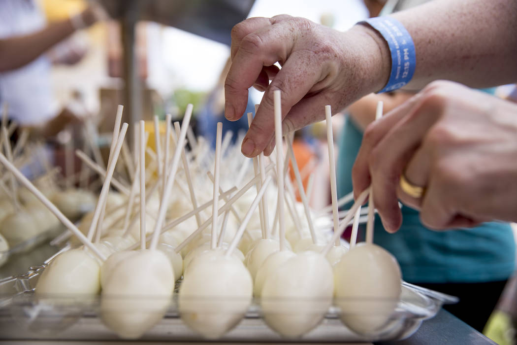 Guests pick up free eggs at the annual White House Easter Egg Roll on the South Lawn of the Whi ...