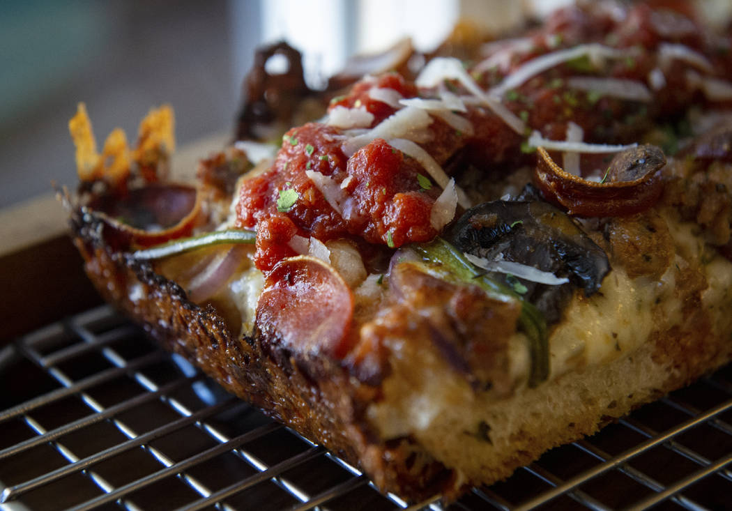 A slice of gluten-free Detroit supreme pizza, also known as the Diana Ross, sits out at Good Pi ...