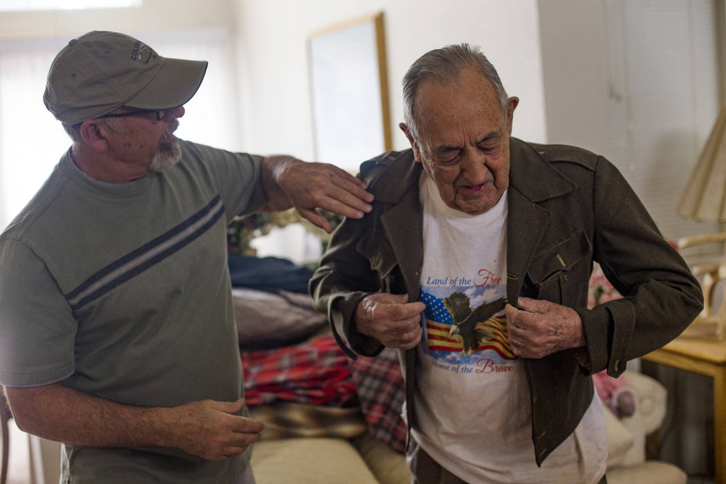 John Zacari helps his father Onofrio "No-No" Zicari put on his jacket from when he wa ...