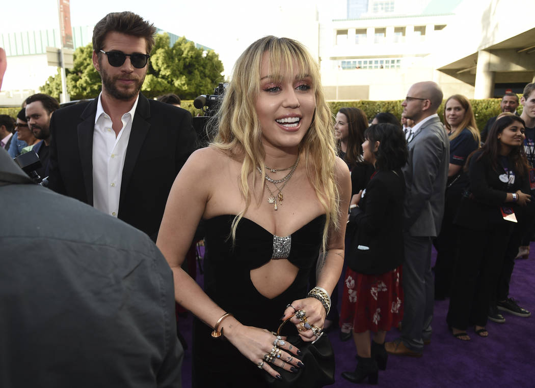 Liam Hemsworth, left, and Miley Cyrus arrive at the premiere of "Avengers: Endgame" a ...