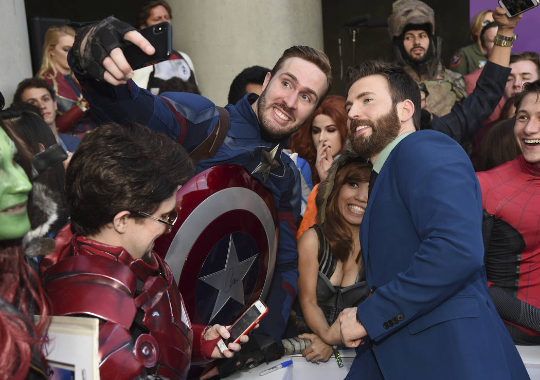 Chris Evans takes a selfie with a fan as he arrives at the premiere of "Avengers: Endgame& ...