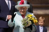 Britain's Queen Elizabeth II waves to the public as she leaves after attending the Easter Matti ...