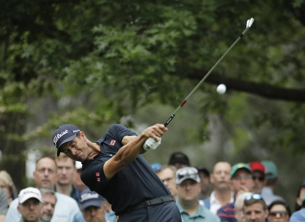 Adam Scott, of Australia, hits from the fourth tee during the final round for the Masters golf ...