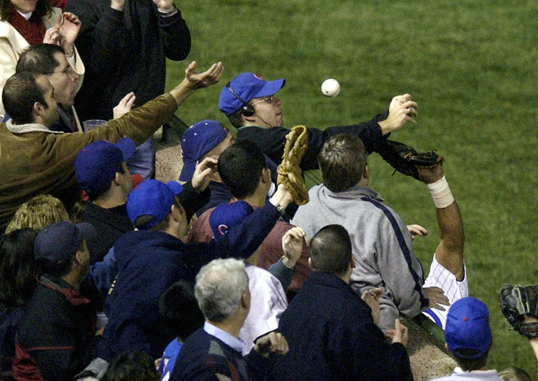 In this Oct 14, 2003 file photo, Steve Bartman catches a ball as Chicago Cubs left fielder Mois ...