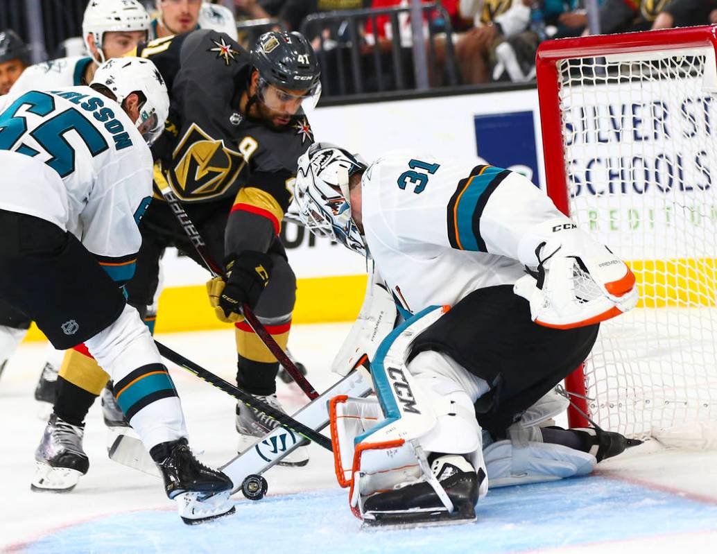 San Jose Sharks goaltender Martin Jones (31) and defenseman Erik Karlsson (65) block a shot fro ...