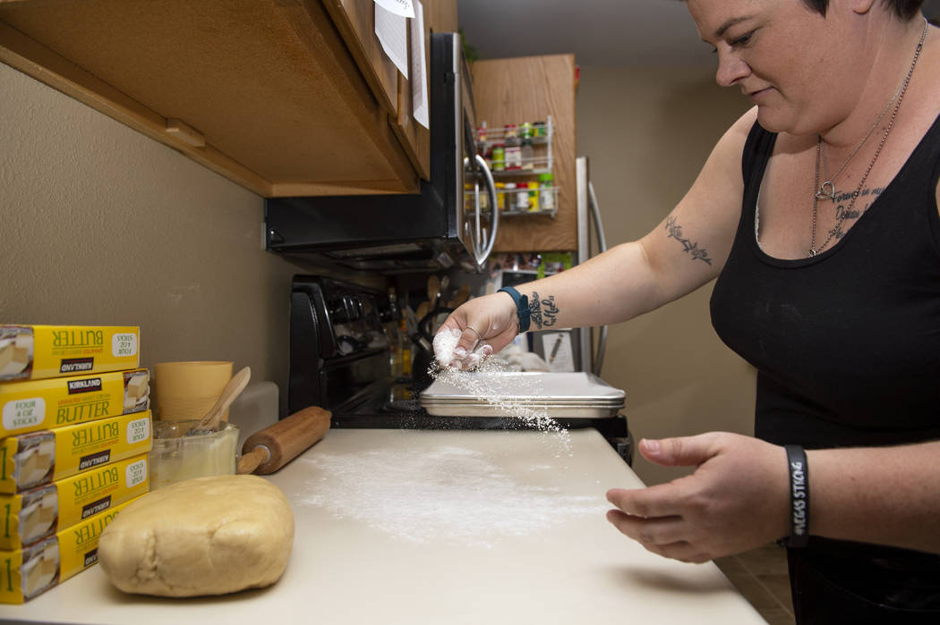 Owner of Cakes, Cookies and Creations Jessica Dejarnett sprinkles flour before she rolls out co ...