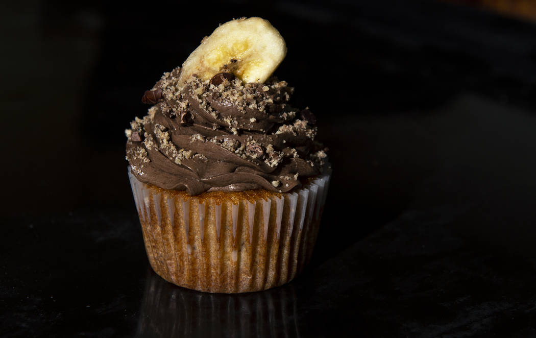 A banana cupcake with chocolate buttercream made by Owner of Cakes, Cookies and Creations Jessi ...
