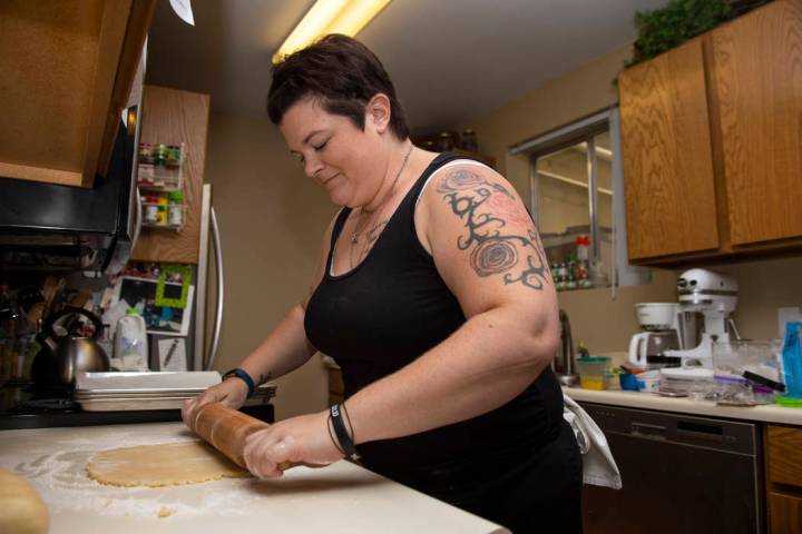 Owner of Cakes, Cookies and Creations Jessica Dejarnett rolls out dough to make sugar cookies i ...