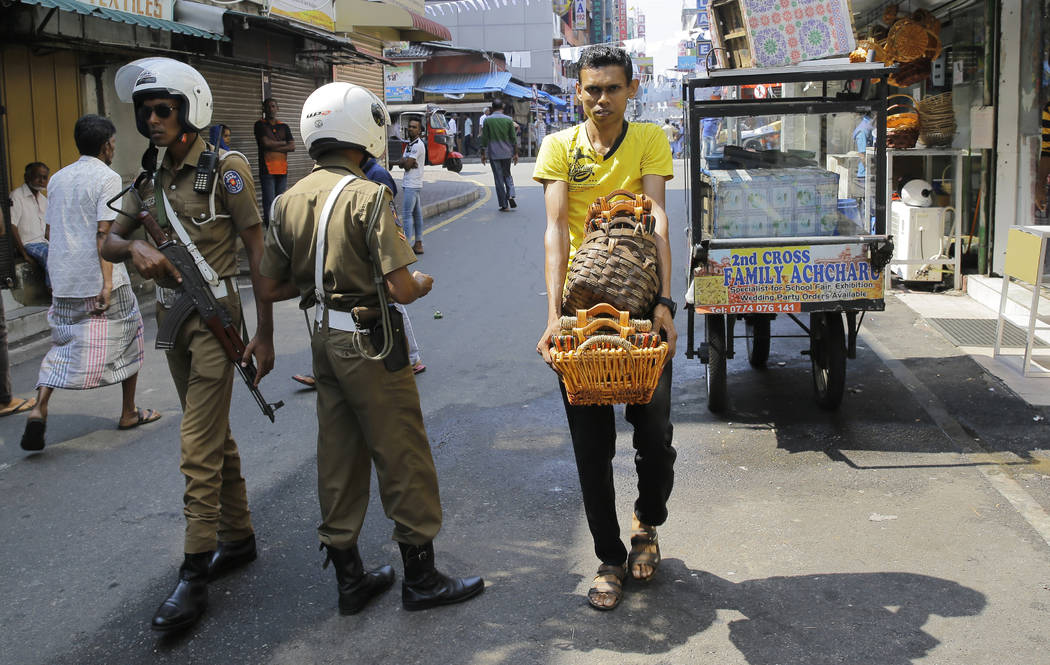 Sri Lankan police officers patrol in a street outside a mosque in Colombo, Sri Lanka, Wednesday ...