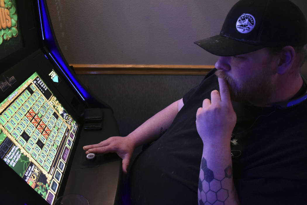 Eric Wieland ponders his next play on a video poker machine at the Palm Grand Casino in Billing ...