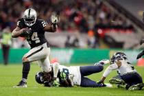 Oakland Raiders running back Marshawn Lynch (24) is tackled by Seattle Seahawks cornerback Shaq ...