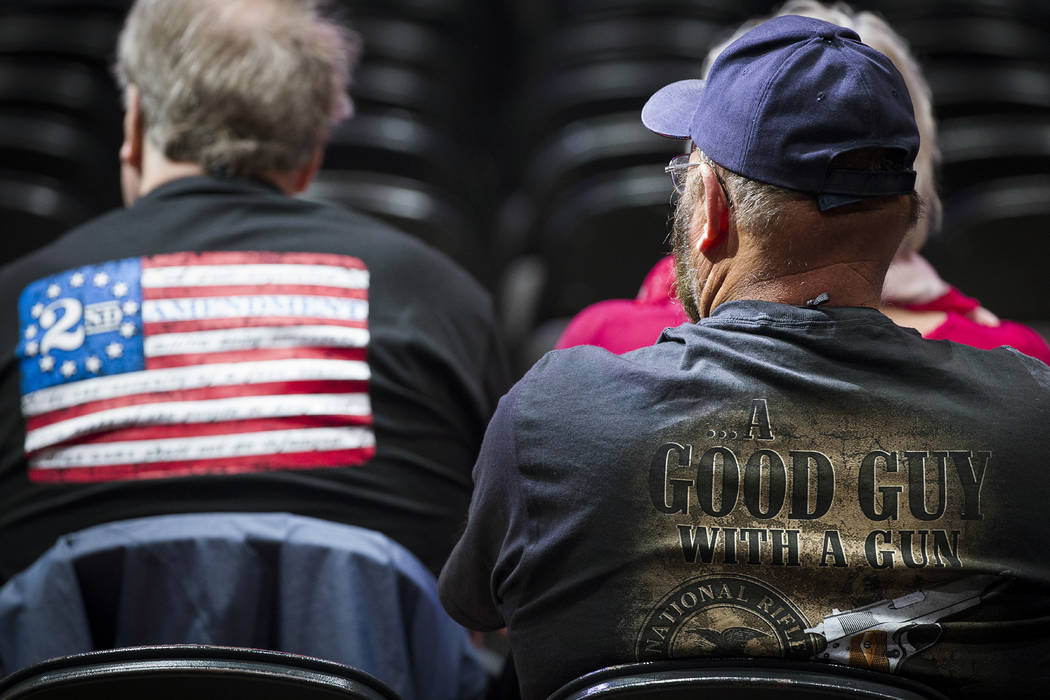 People in the audience wait for the start of the National Rifle Association-Institute for Legis ...