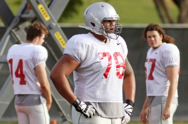 UNLV's Justin Polu, center, sits out on a drill rotation and watches teammates at UNLV football ...