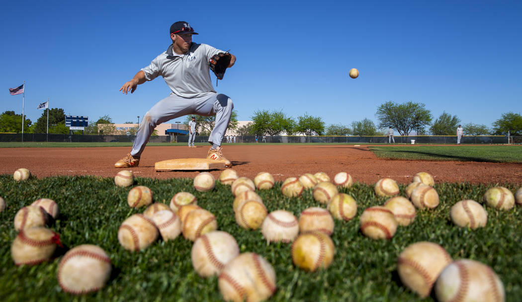 The Meadows School third baseman Sam Kaplan looks in a high ground ball during fielding practi ...