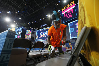 A worker cleans seating on the NFL stage ahead of the first-round NFL Draft, Wednesday, April 2 ...