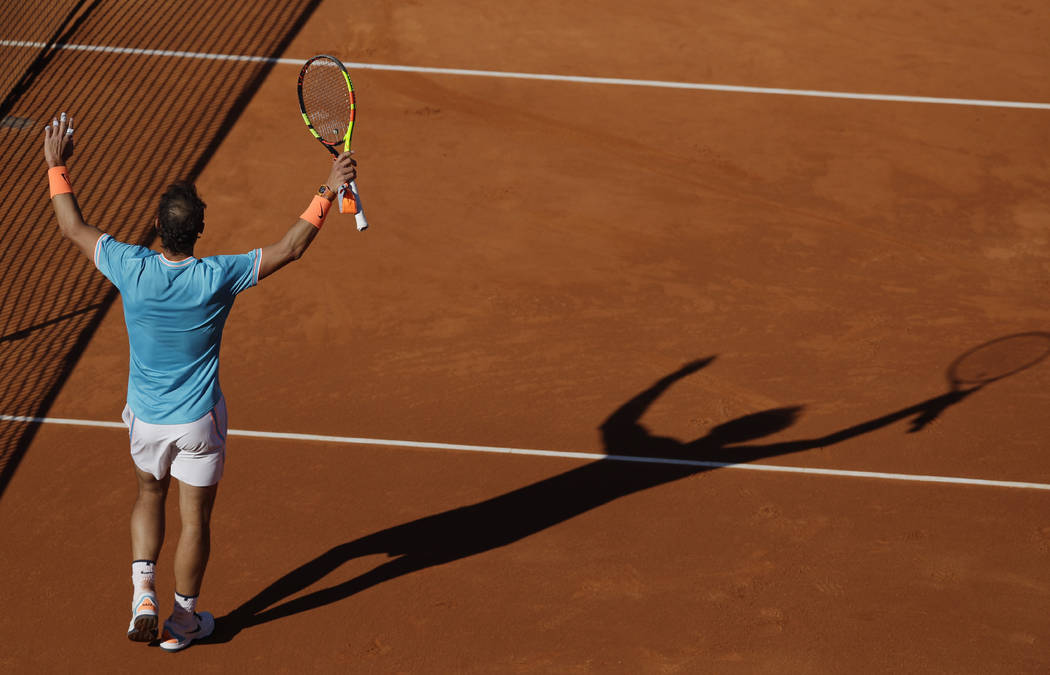 Spain's Rafael Nadal raises his racket on the court after winning his men's singles match again ...