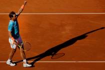 Spain's Rafael Nadal raises his arm after winning his men's singles match against Argentina's L ...