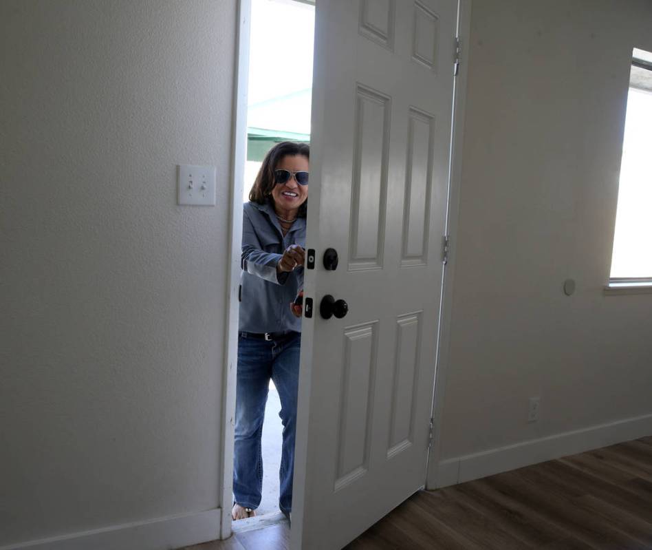 Ana Martinez, a veteran who was homeless two years ago, walks into her new Las Vegas home for t ...