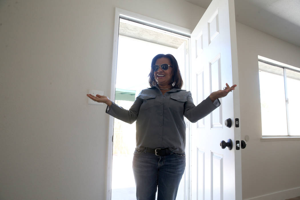 Ana Martinez, a veteran who was homeless two years ago, walks into her new Las Vegas home for t ...