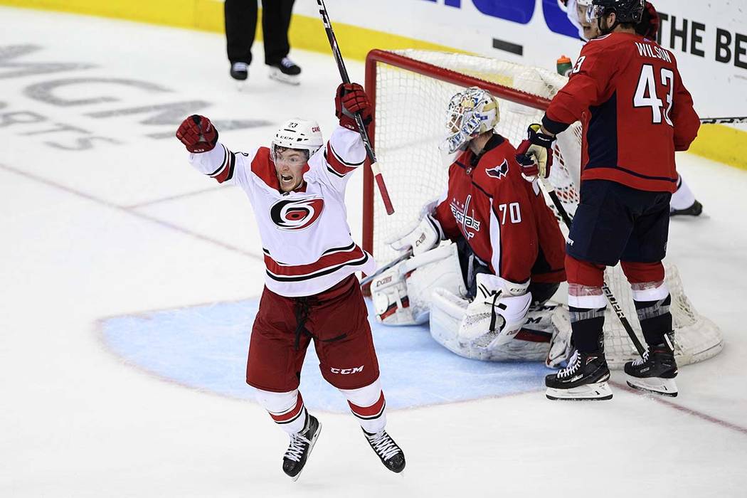 Carolina Hurricanes left wing Brock McGinn, left, celebrates his game-winning goal during doubl ...