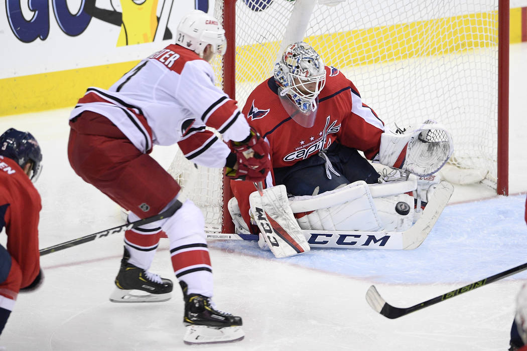 Washington Capitals goaltender Braden Holtby (70) watches the puck against Carolina Hurricanes ...