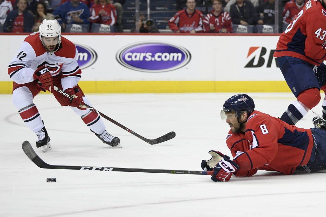 Washington Capitals left wing Alex Ovechkin (8), of Russia, reaches for the puck against Caroli ...