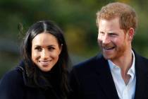 FILE - In this Dec. 1, 2017 file photo, Britain's Prince Harry and his fiancee Meghan Markle ar ...