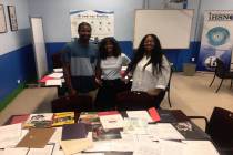 Anthony, Antoinette and Yolanda Love take a photo with some of the 115 college acceptance lette ...