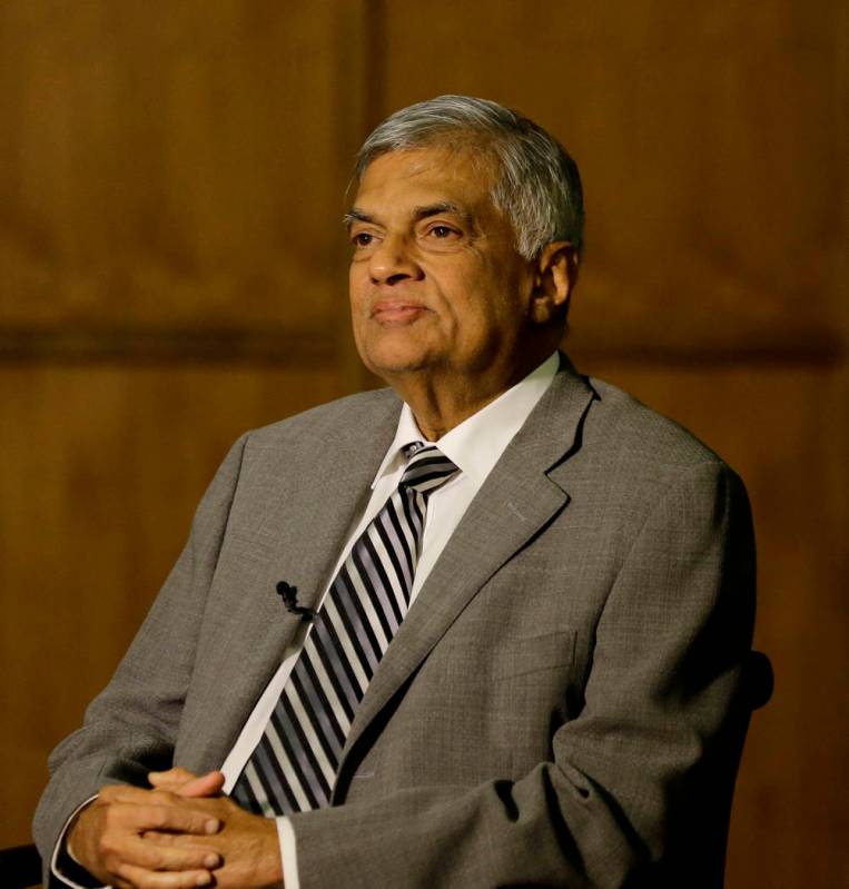 Sri Lankan Prime Minister Ranil Wickremesinghe takes a question during an interview with the As ...