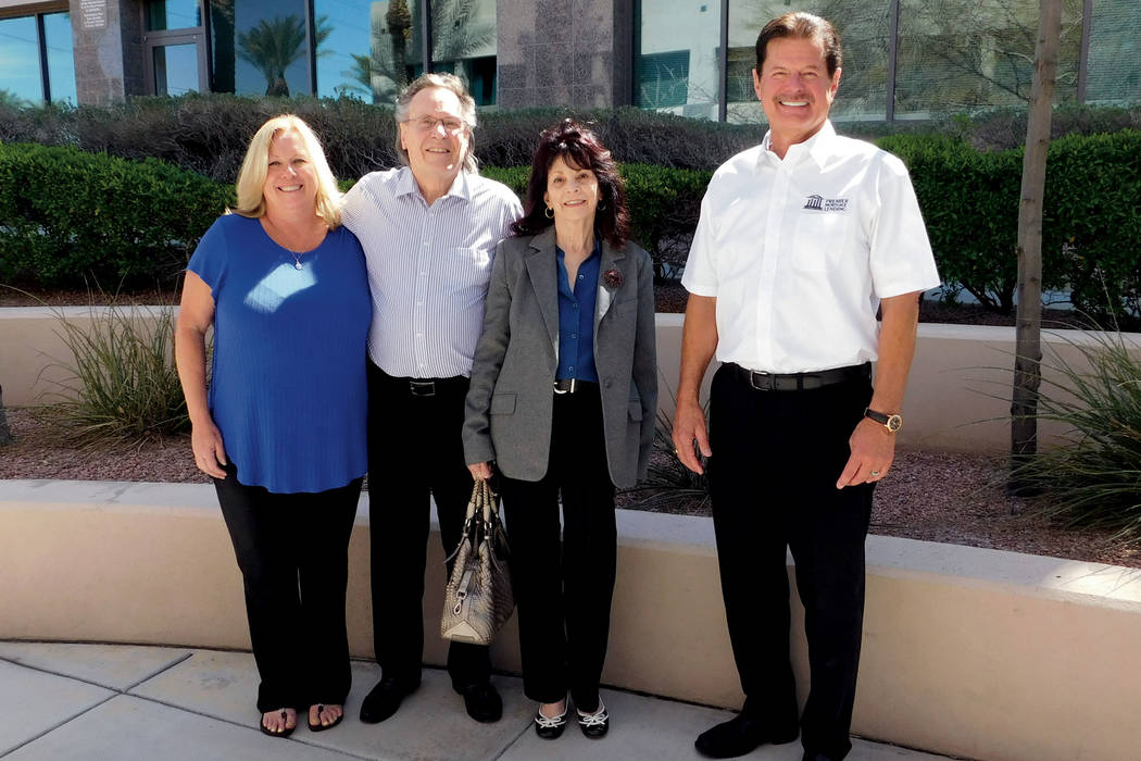 Andrea Hall and Rick Piette, far left and right, of Premier Mortgage with homebuyers John and S ...