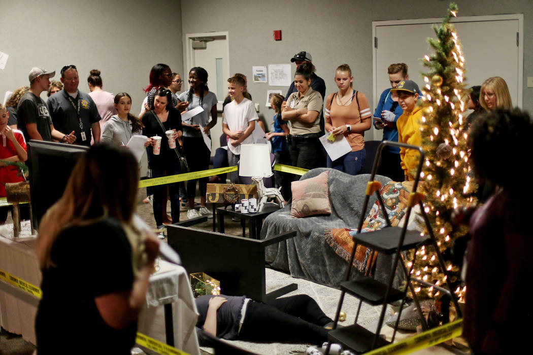 Children examine a fake crime scene at the coroner office's Take Our Daughters and Sons to Work ...