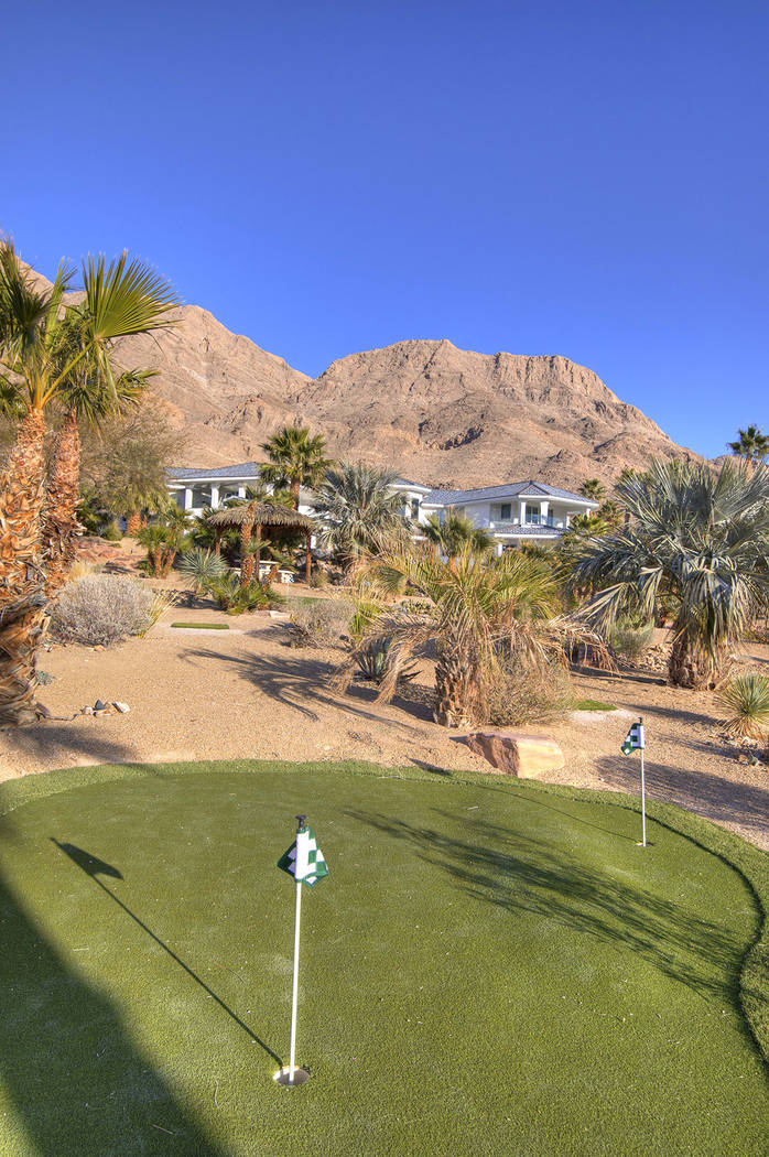 A six-hole putting green lies beneath the palm trees. (Sotherby’s International Realty, Synergy)