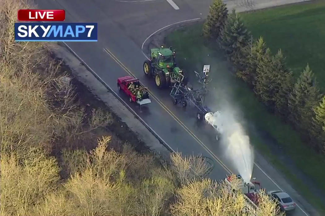 In this still image from video provided by ABC7 Chicago, a fire engine sprays water on a contai ...